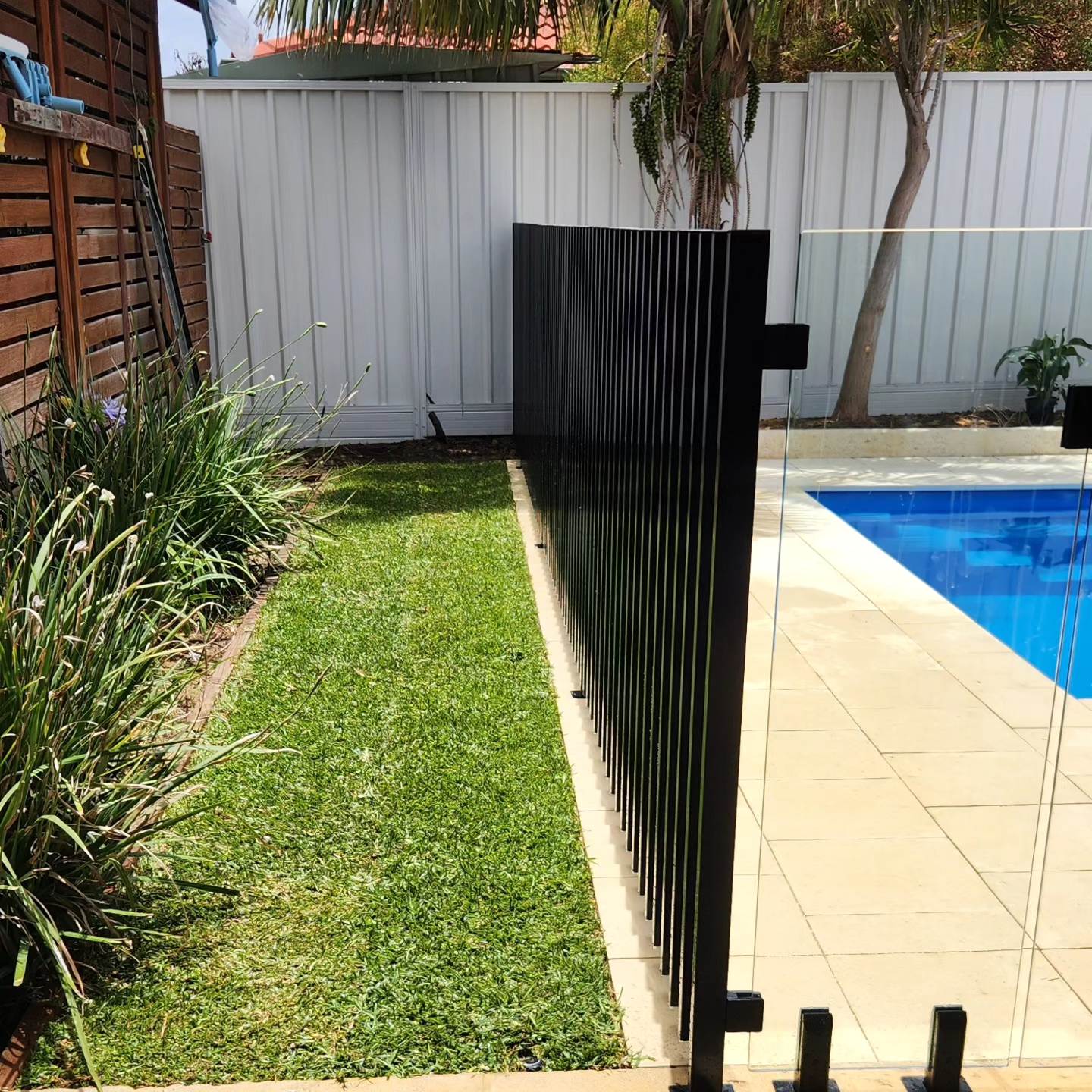 Custom made vertical batten pool fencing, designed and installed by Secure Fit Fencing, Perth