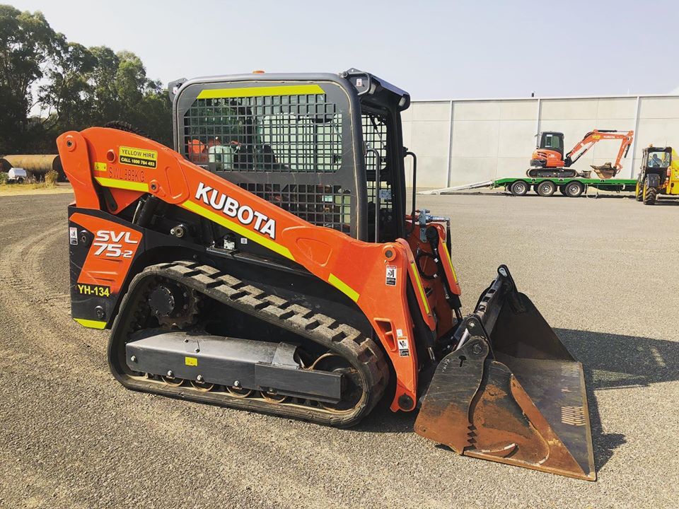 Yellow Hire bobcat on trailer